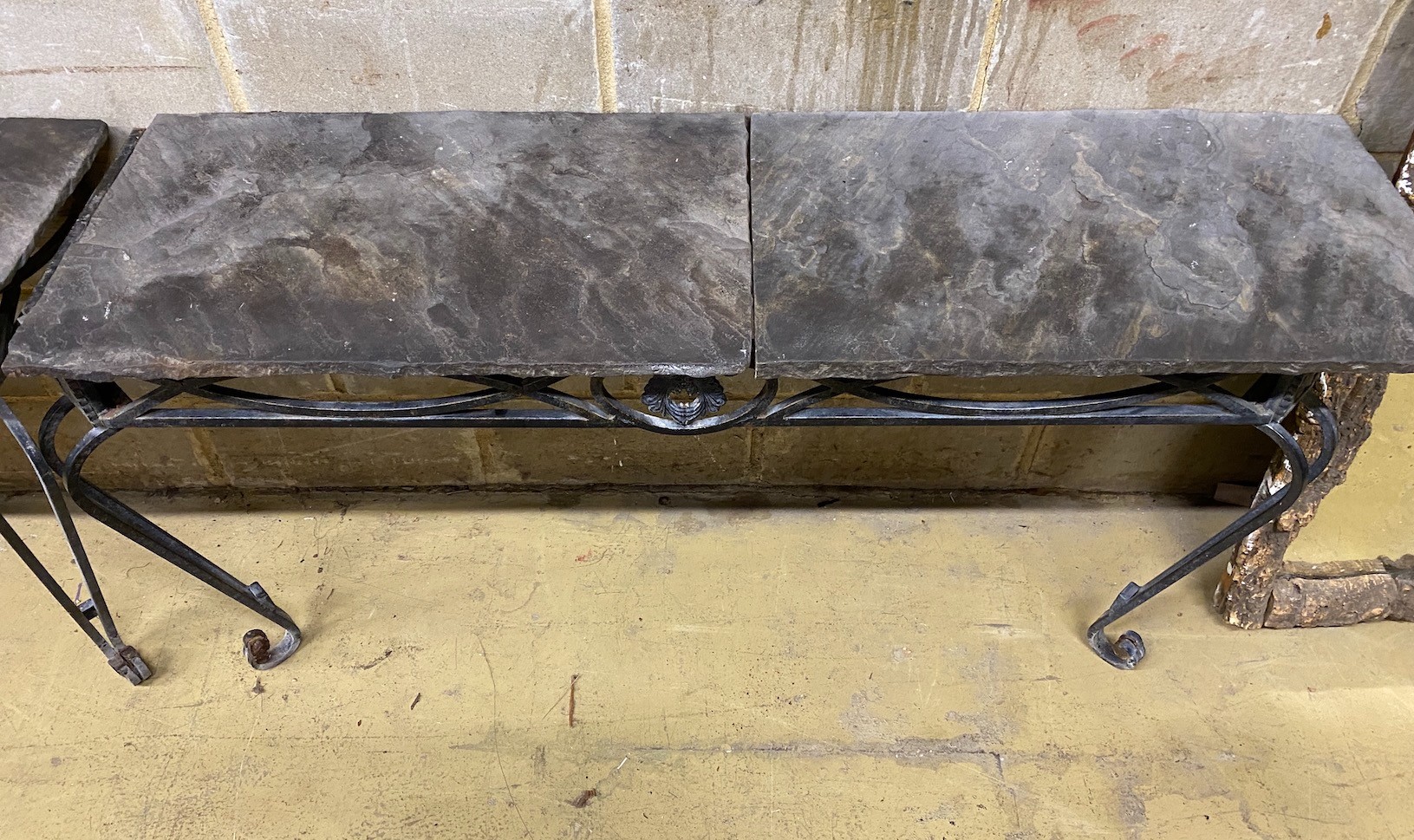 A pair of wrought iron slate top console tables, width 146cm, depth 45cm, height 75cm
